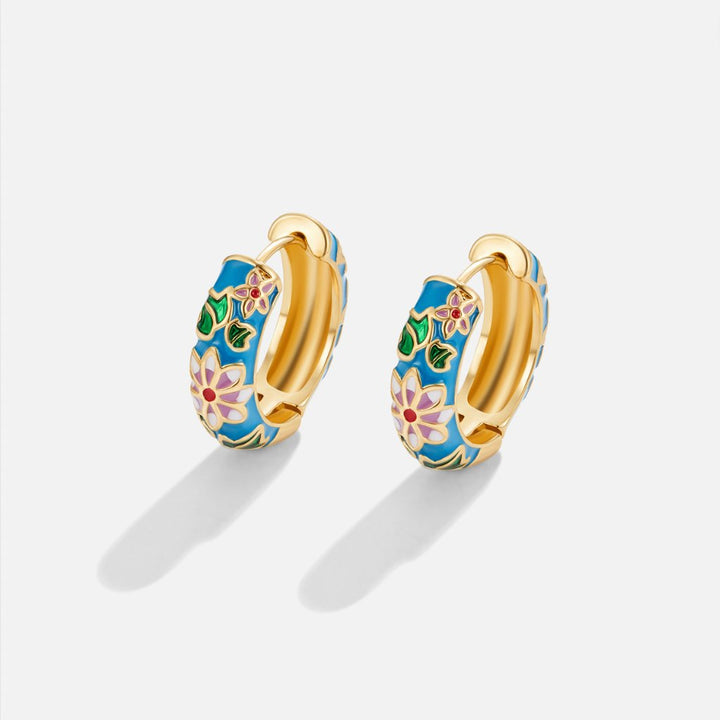Brincos de argola dourados com flor